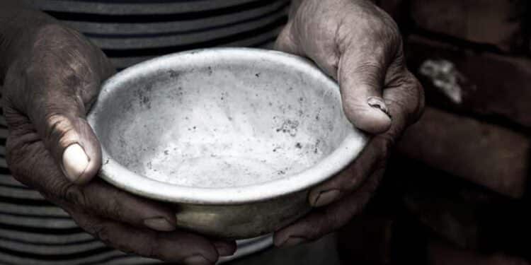 the poor old man's hands hold an empty bowl. the concept of hung