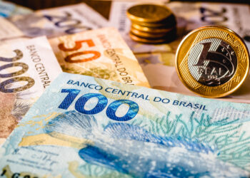in this photo illustration being displayed one hundred and two hundred reais bills and a one reais coin highlighted. the real is the current money in brazil