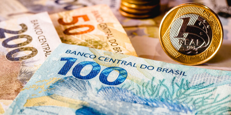 in this photo illustration being displayed one hundred and two hundred reais bills and a one reais coin highlighted. the real is the current money in brazil
