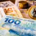 in this photo illustration being displayed one hundred and two hundred reais bills and a one reais coin highlighted. the real is the current money in brazil